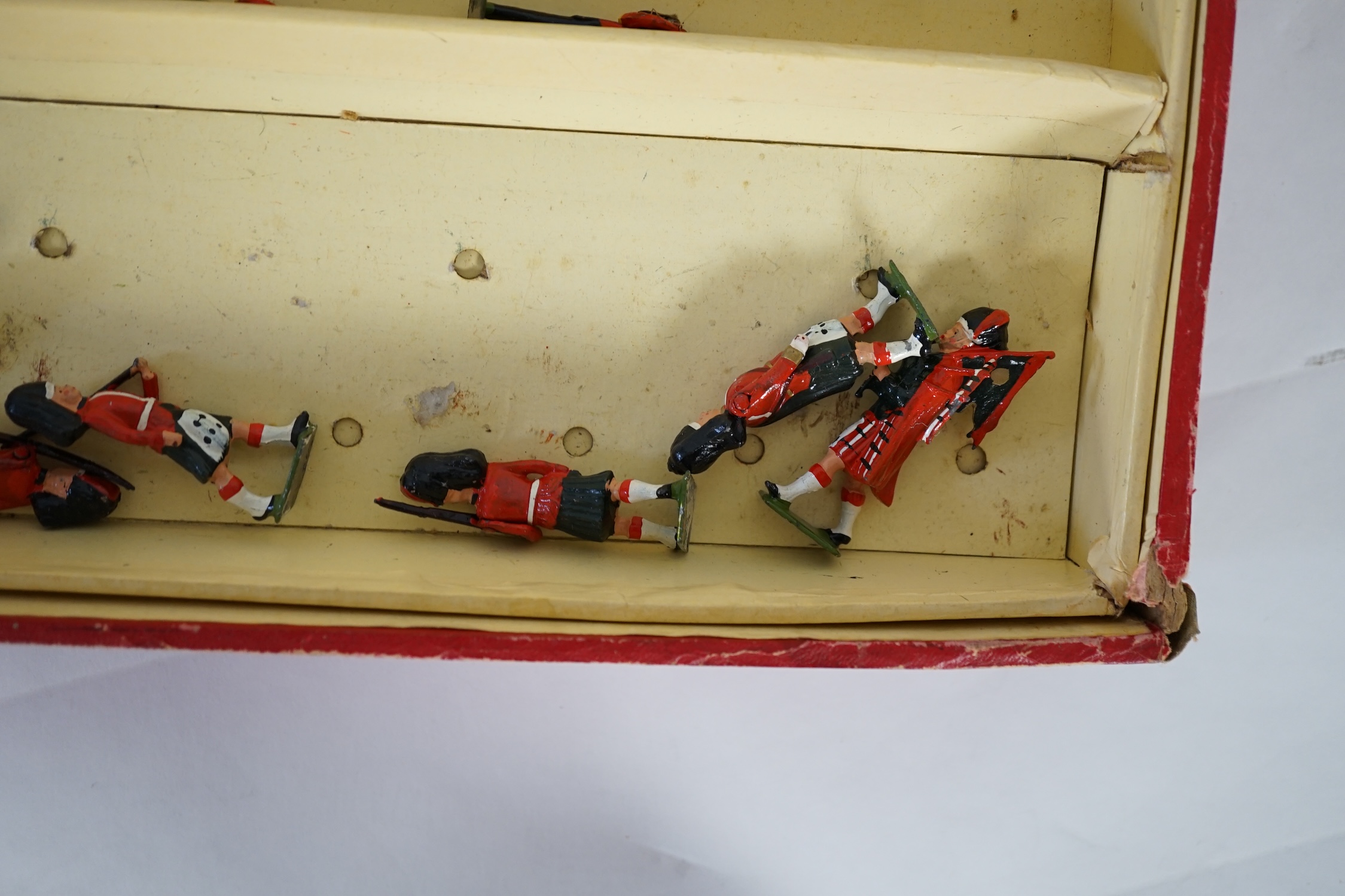 A Britains ‘Regiments Of All Nations’ series box of lead soldiers, including twelve Scottish Highlander infantrymen, eleven marching bandsmen